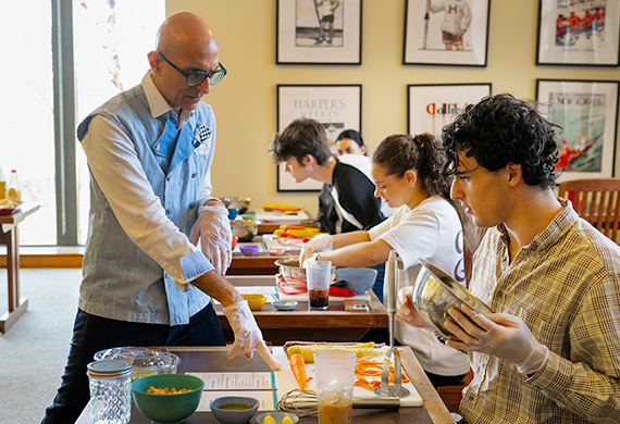 Image of Guest Chef Mehta helps students navigate the recipe. Photo by Carlo de Jesus/Marist University.