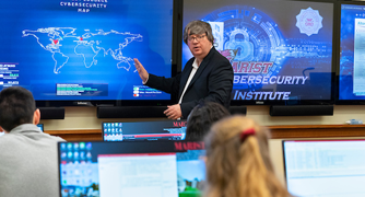 Image of a computer science faculty member teaching class.