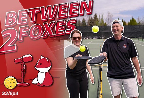 Image of President Weinman and Prof. Matheus with pickleball paddles, including the Between 2 Foxes logo and
