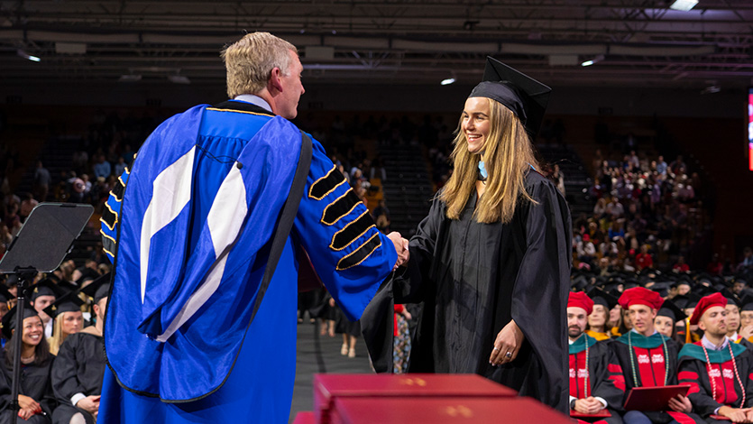 President Weinman and graduate student at Friday's Commencement. Photo by Carlo de Jesus/Marist College.