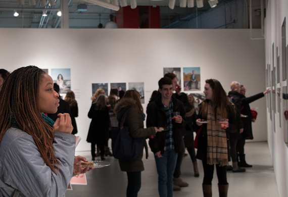 Image of a student looking at photography in the Steel Plant Art Gallery.