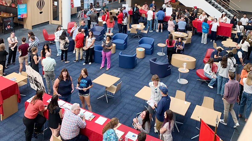 Image of prospective students and their families in the Dyson Center atrium.