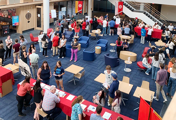 Image of prospective students and their families in the Dyson Center atrium.