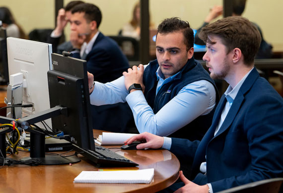 An image of students collaborating in a class.