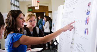 image of student reading someone's research presentation