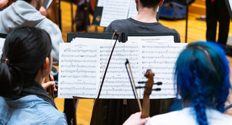 Image of students at a music rehearsal.