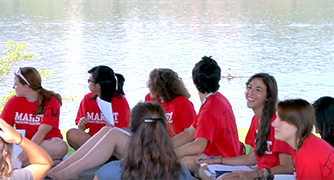 An image of students sitting outside.