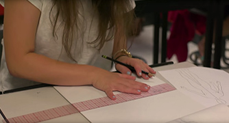 An image of a student working on a sketch. 