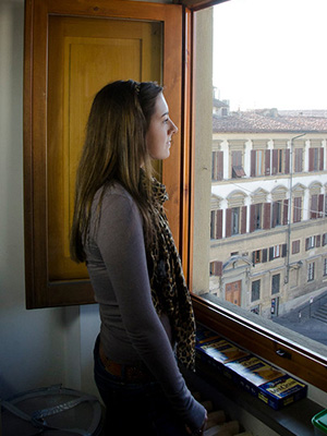 Photo of student looking out a window at Florence