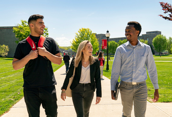 An image of three students walking to class. 