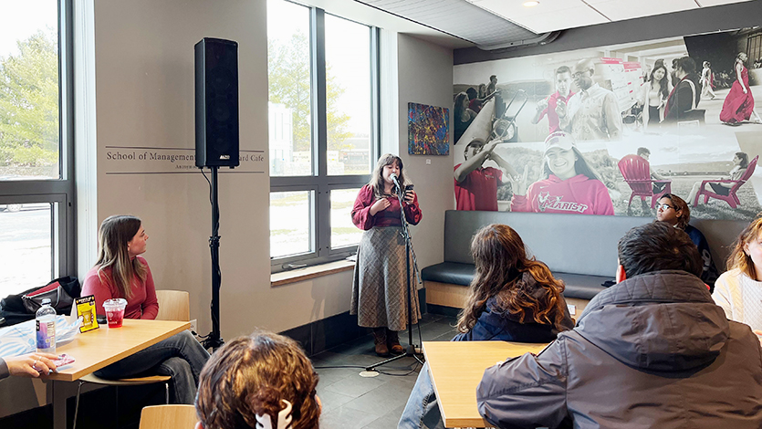 Image of Isabel Padilla reading her poem at the poetry reading in Saxbys cafe.