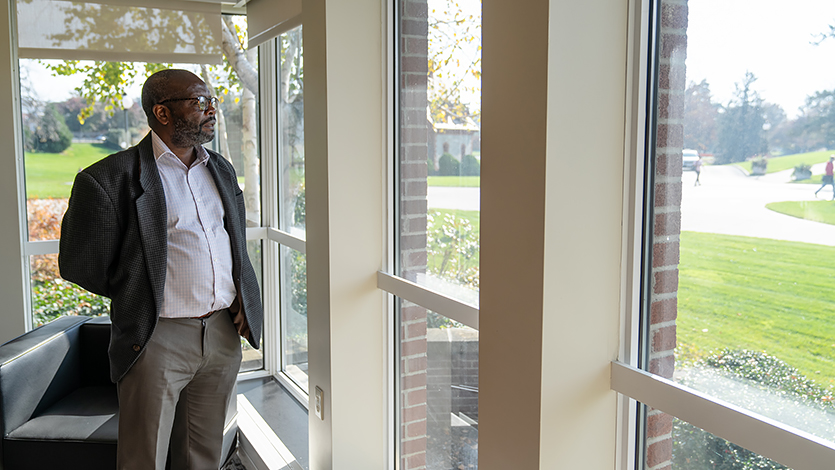 Dr. Antonio looking out his office windows