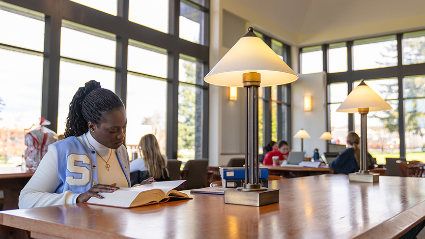 Image of student studying in library.