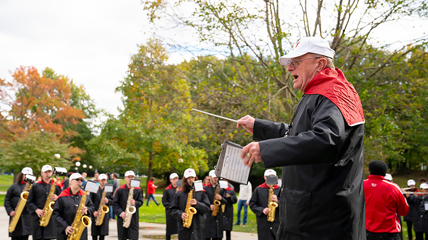 Image of Art Himmelberger conducting the marching band in 2018.