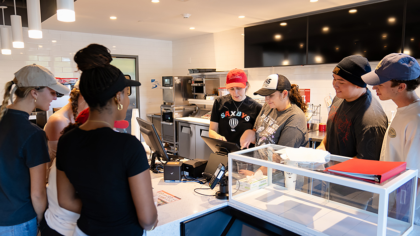 Student CEO Mabel Aronson ’25 leads her team through a training session in preparation for the Saxbys student-run cafe grand opening. 