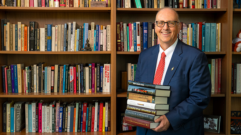 Dean Lamb with his extensive office bookshelf collection. Photo by Carlo de Jesus/Marist College. 