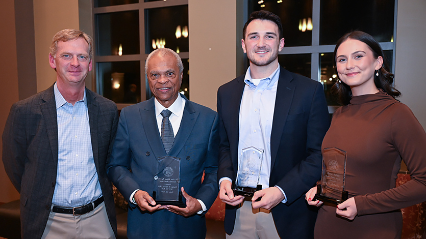 Image of President Weinman with alumni award winners.