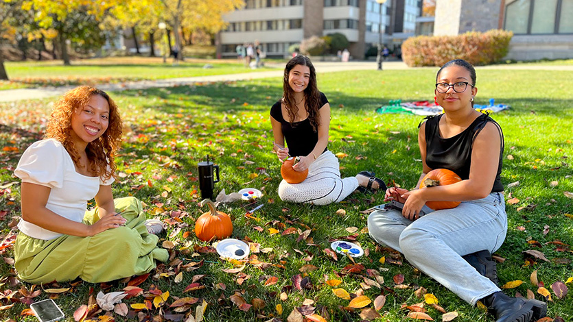 Image of students painting pumpkins.