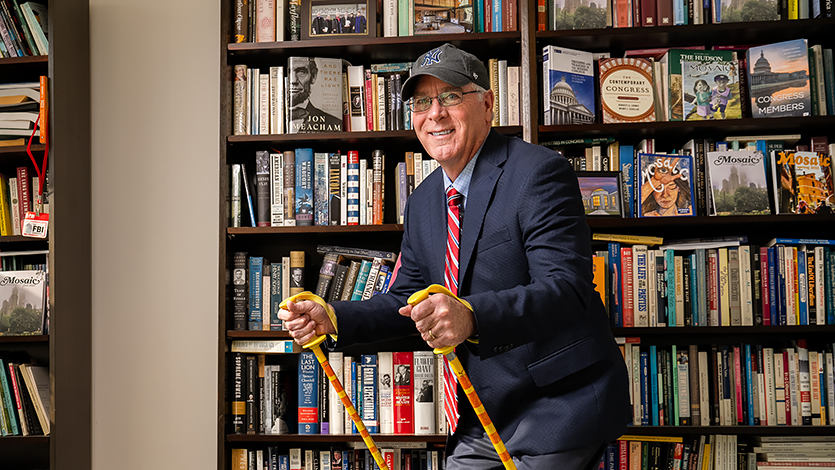 Image of Dean Shaffer in his office with ski poles.