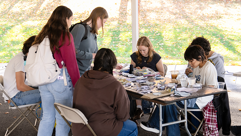 Students working at the Repair Cafe at the SEED Sustainability Fair alongside other environmentally focused groups. 