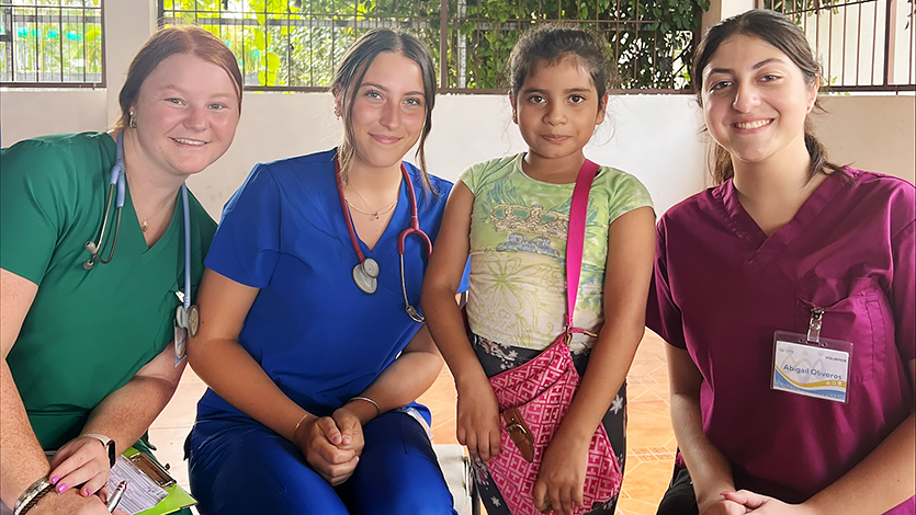 Image of Jenna Jedlicka, Kiana Salierno, and Abigail Oliveros with a patient in Costa Rica.