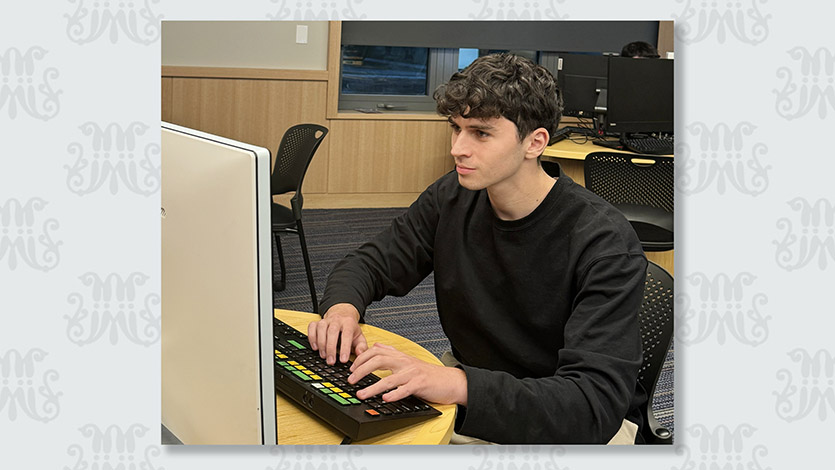 Andrew Dekhtyar ’26, pictured in the Investment Center in Dyson, joined the Mentorship Program to gain valuable insights for a future career in finance