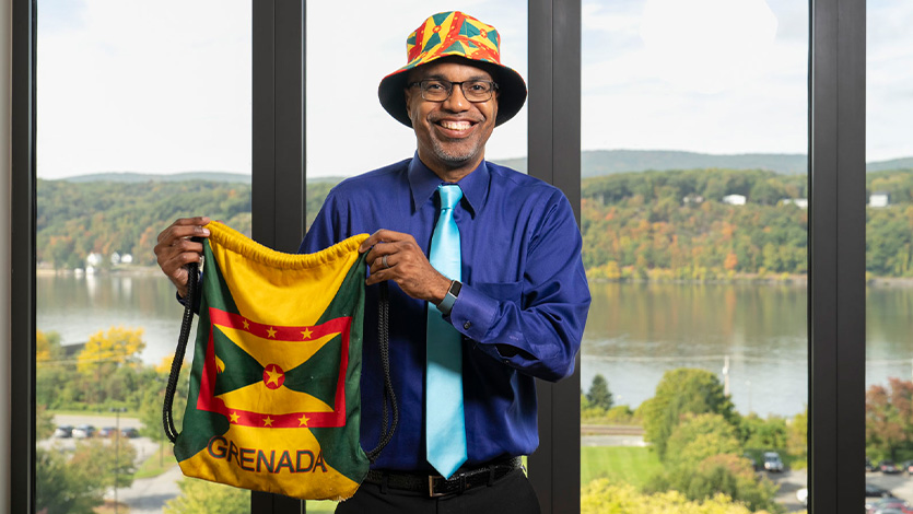 Image of Dr. Buckmire with Grenada apparel. 