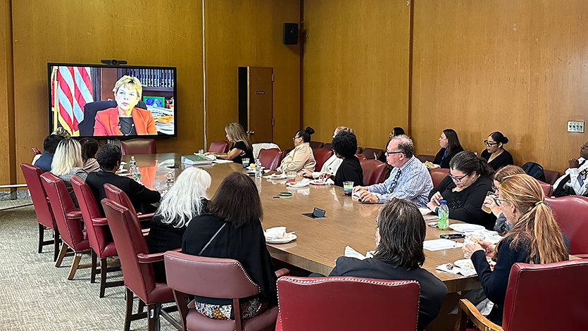 Image of viewers at the Queens County Criminal Courts Building watching Judge Hirsch’s interview in the documentary.