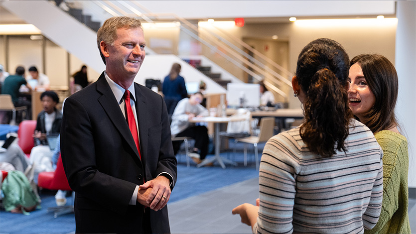 Image of President Weinman and students.