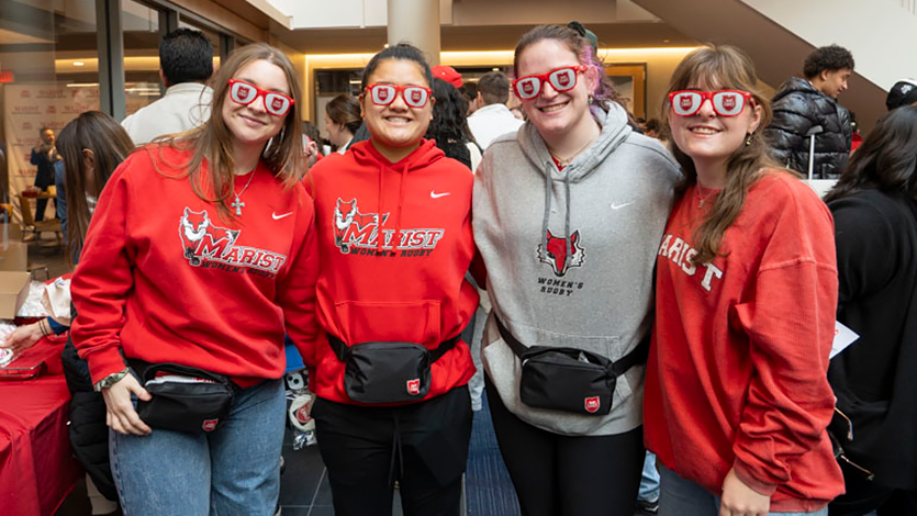 Image of students wearing stylized glasses with the new Marist University shield logo.