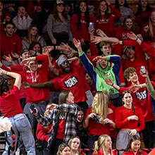 Image of students cheering at a basketball game.