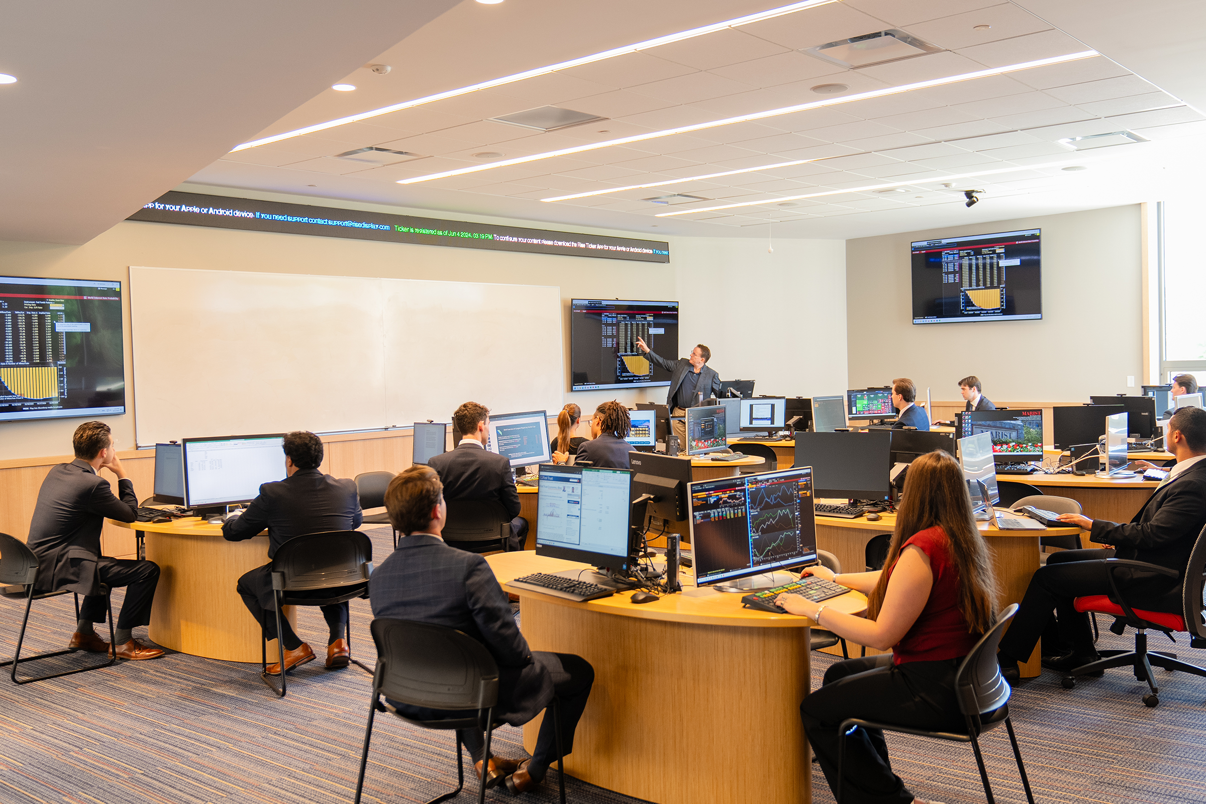 An image of students working with a professor