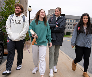 Image of Jackie Piddock walking with friends on campus.