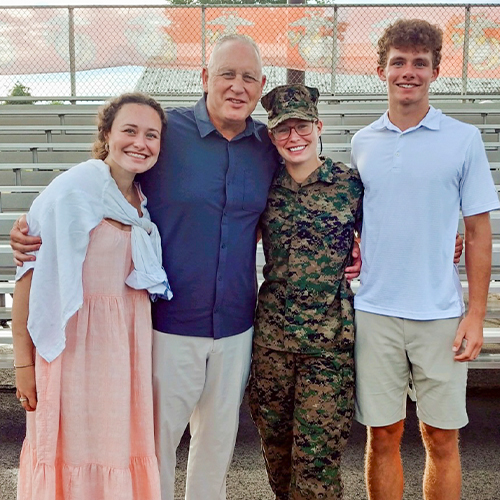 Image of Jackie Piddock in her military uniform with her family.