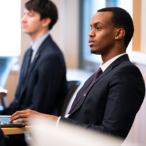 Image of Loik Makuza sitting in class.