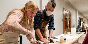 Image of students displaying research at a campus event.